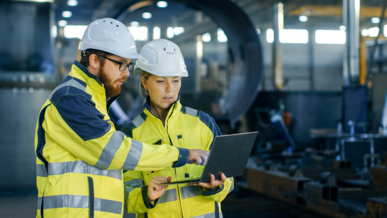 Construction workers looking at data